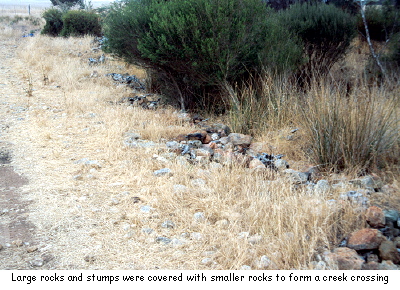 Large rocks and stumps were covered with smaller rocks to form a creek crossing